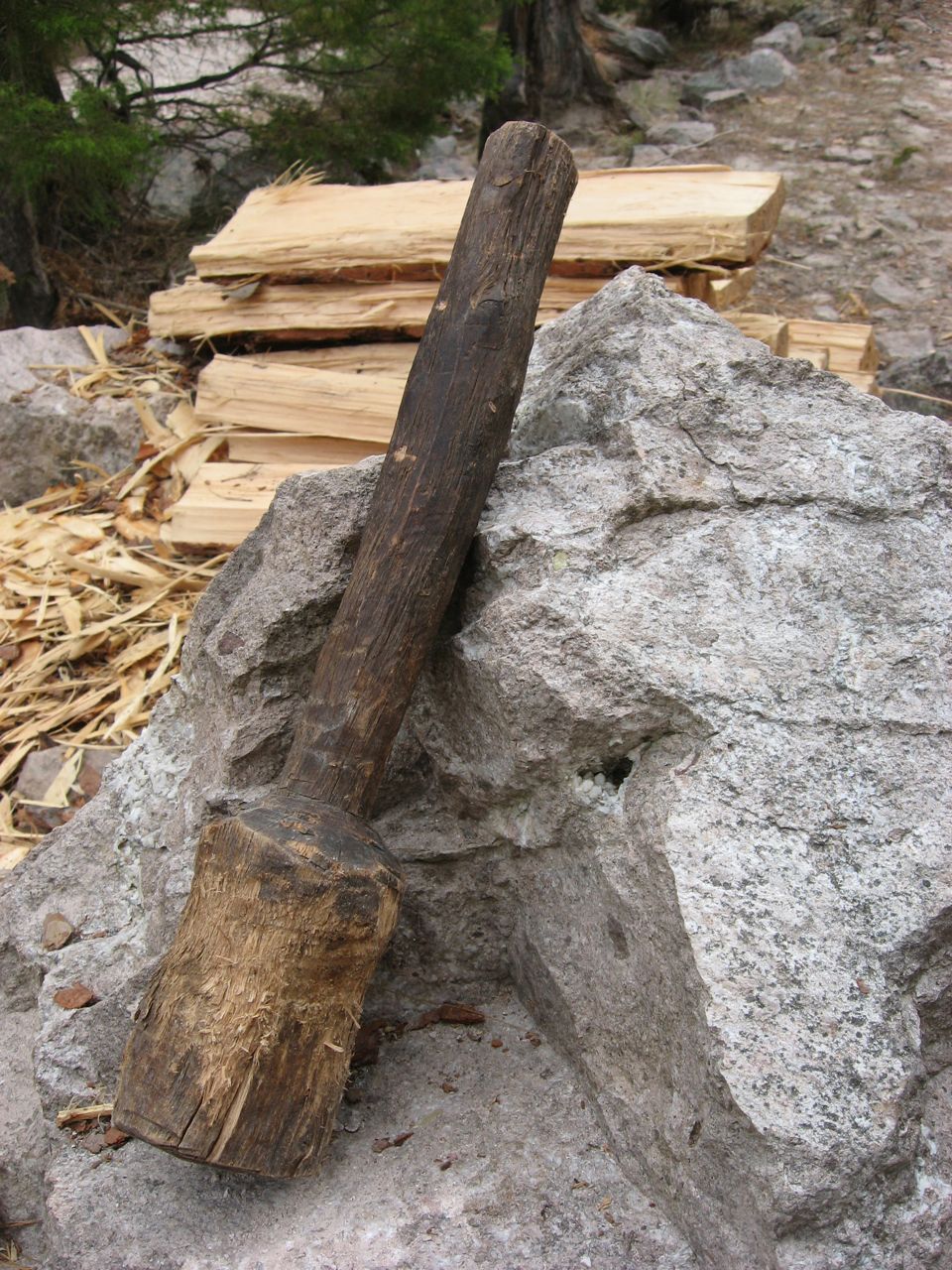 Soft cedar shingles are split with a fire hardened oak wedge.