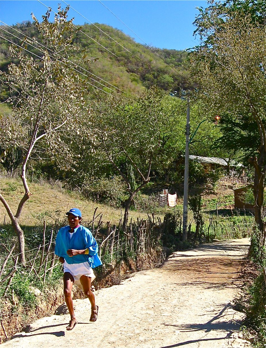 His traditional blouse flying in the wind, a Tarahumara runner make good time in handmade huaraches.